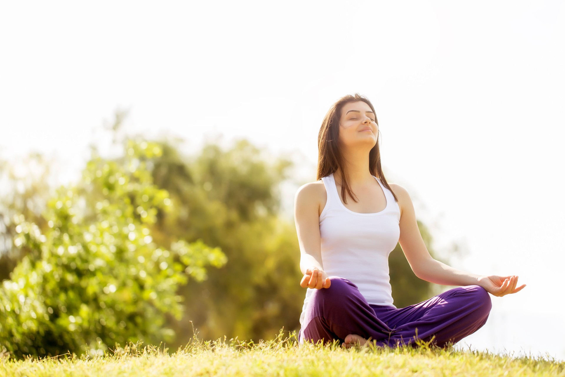 Young Woman Meditating in Field